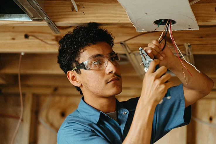 Electrician training program student working in class